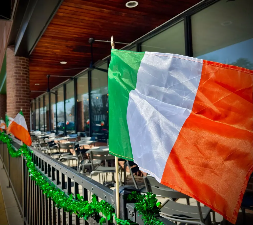 An Irish flag hanging over the patio rail